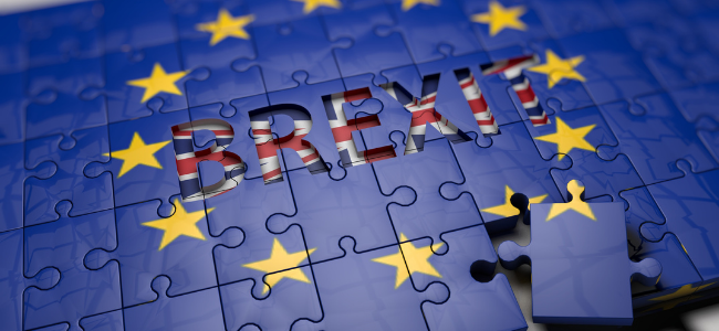 A jigsaw puzzle featuring the flag of the European Union. One piece, showing part of the UK flag, is missing, revealing the word "BREXIT" underneath—a poignant reminder in 2021 of ongoing legal updates and their implications on employment.