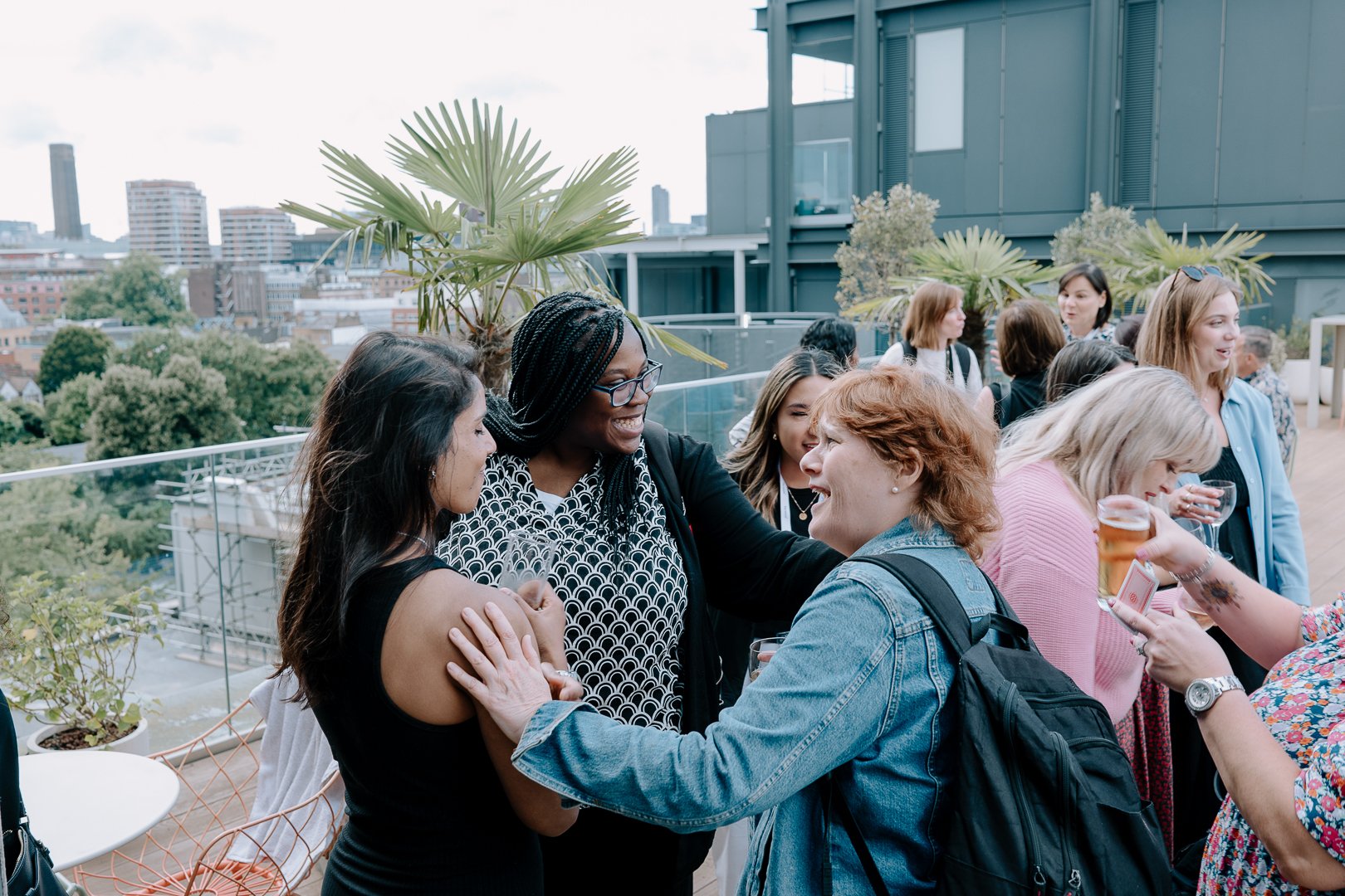 Signature Summer Social with clients on a rooftop talking to each other